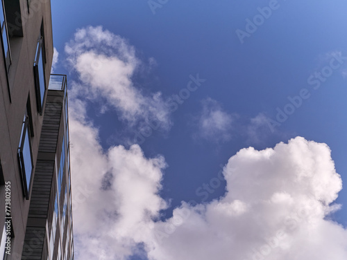White fluffy cumulus clouds in the summer sky, natural clouds background