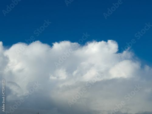 White fluffy cumulus clouds in the summer sky, natural clouds background © Studio-M