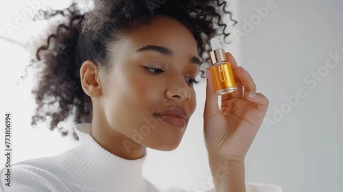 Young Woman Examining Facial Serum for Skincare Routin photo