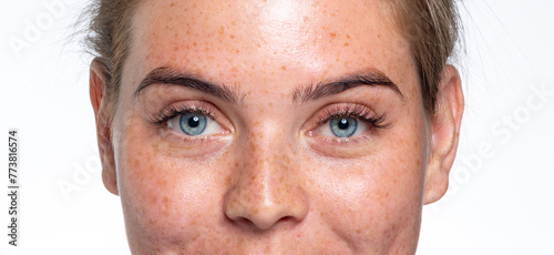 A close up of a person with blue eyes looking at the camera