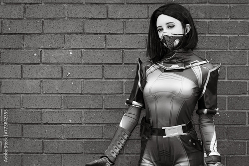 Valokuva Grayscale photo of a cosplayer in front of a brick wall