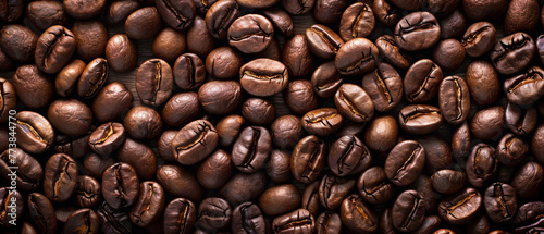 Roasted coffee beans on the table for background or design, top view.