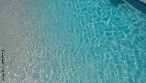 A close-up of the rippling and sparkling water surface of the pool seen from directly above.                                                                                        