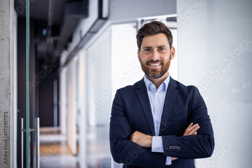 Confident smiling businessman in office setting portrait