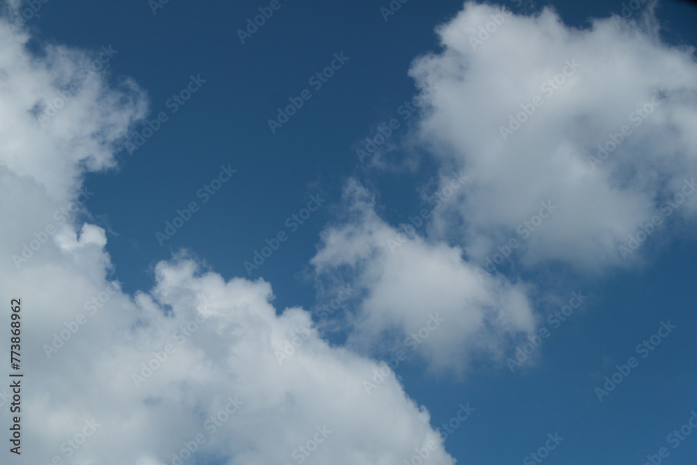 Clouds in the blue sky on a sunny day. Sunny sky background