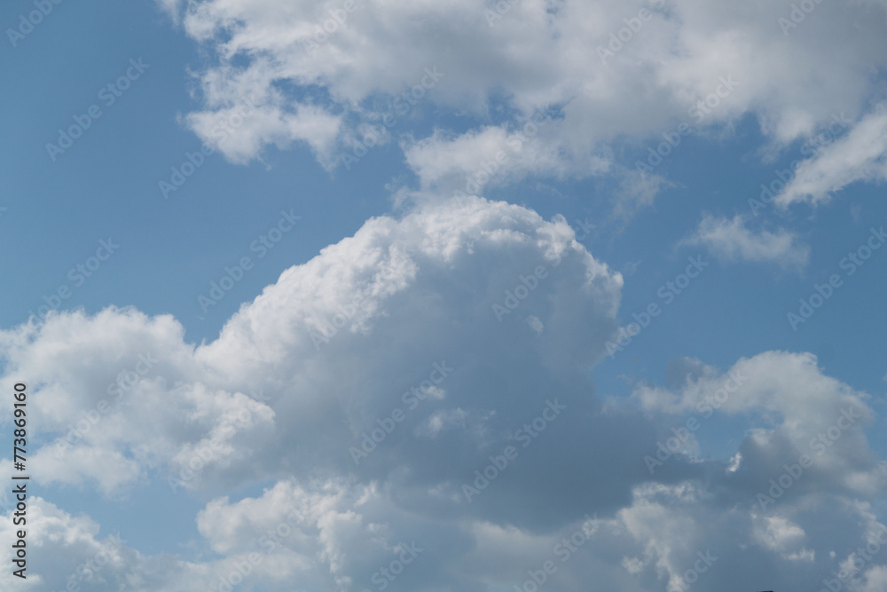 Clouds in the blue sky on a sunny day. Sunny sky background Clouds in the blue sky on a sunny day. Sunny sky background
