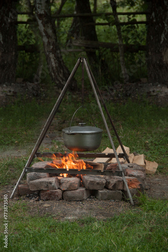 Cauldron on fire. Cooking food on fire. Food in nature