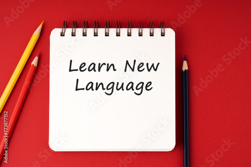Learn new language text on notepad on red background