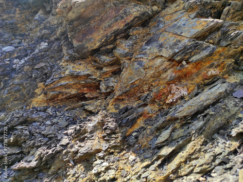 Geodesy. Stone texture. The rock is brown and red. Mineral background. Design from natural materials.