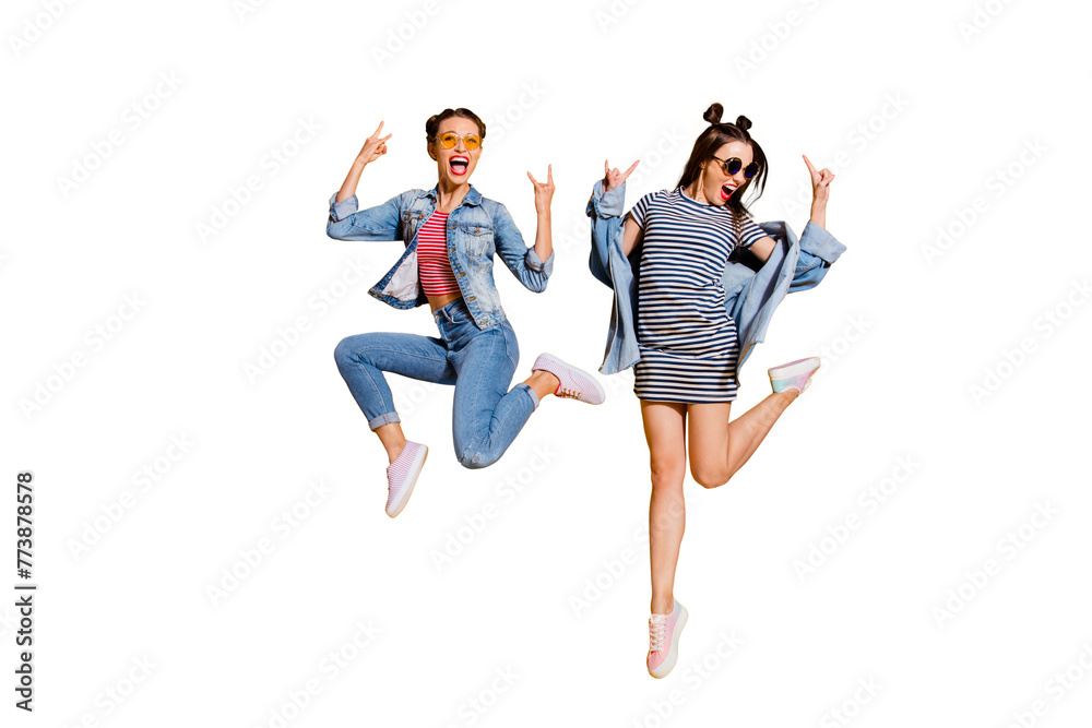 Full legs body size two music lover lady with emotion reaction facial expression wear in glasses spectacles street style stylish trendy casual outfit isolated on yellow wall give heavy metal gesture
