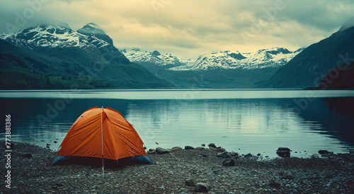 Immerse in the Y2K aesthetic with an orange tent amidst calm waters and snowy peaks. Captured with Provia film, the scene boasts tranquility and AI generative enhancements. photo