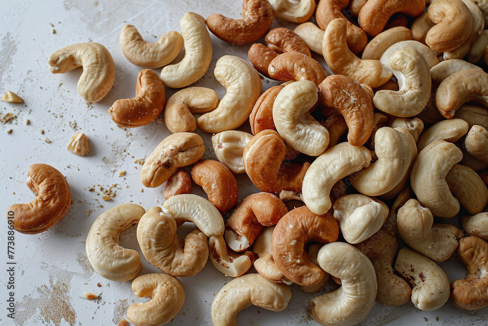 Delicious cashew nuts scattered on the tabletop, top view. Generated by artificial intelligence Delicious cashew nuts scattered on the tabletop, top view. Generated by artificial intelligence