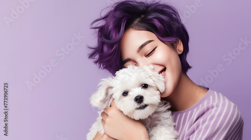 a young asian woman with a beautiful haircut and purple hair color is holding a poodle puppy. hairdressing and hair dyes, copy space photo