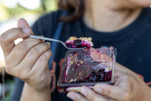 selective focus blueberry cheesecake in the fat Woman's Spoon Who likes to eat cakes and desserts.