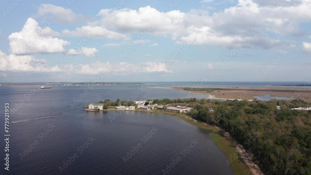Aerial wide rising shot of Fort Johnson with Fort Sumter in the distance in Charleston Harbor, South Carolina. 4K