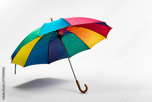 Colorful rainbow umbrella on white background, studio shot. Vibrant multi-colored umbrella open and isolated on a white backdrop. Advertising object concept. Copy ad text space