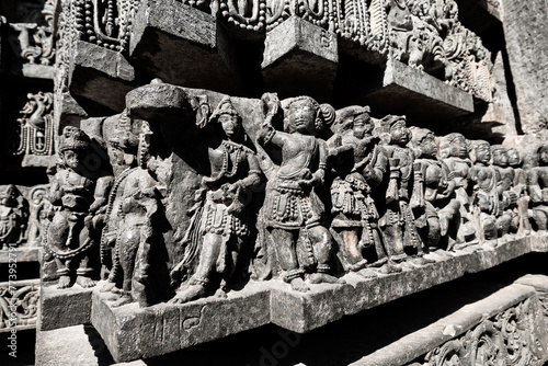 Beautiful carvings of dancing figurines on the wall of the ancient Hoysaleshwara temple in Halebidu.