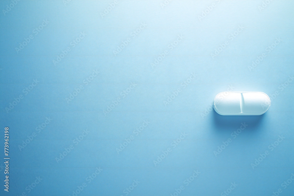 Pill on blue background, medicine concept Pill on blue background, medicine concept