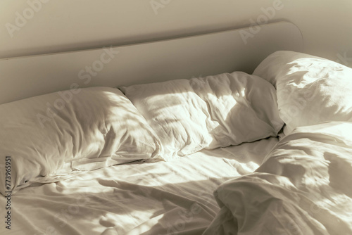 bed in bedroom with white pillows