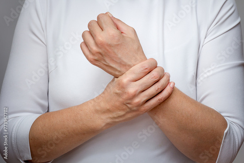 Woman hands showing wrist pain over cropped body