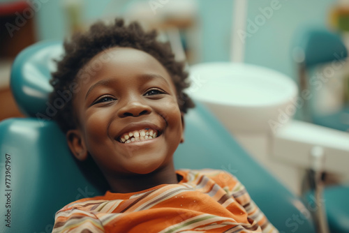 Happy afro kid on regular check up of teeth in dental clinic  photo