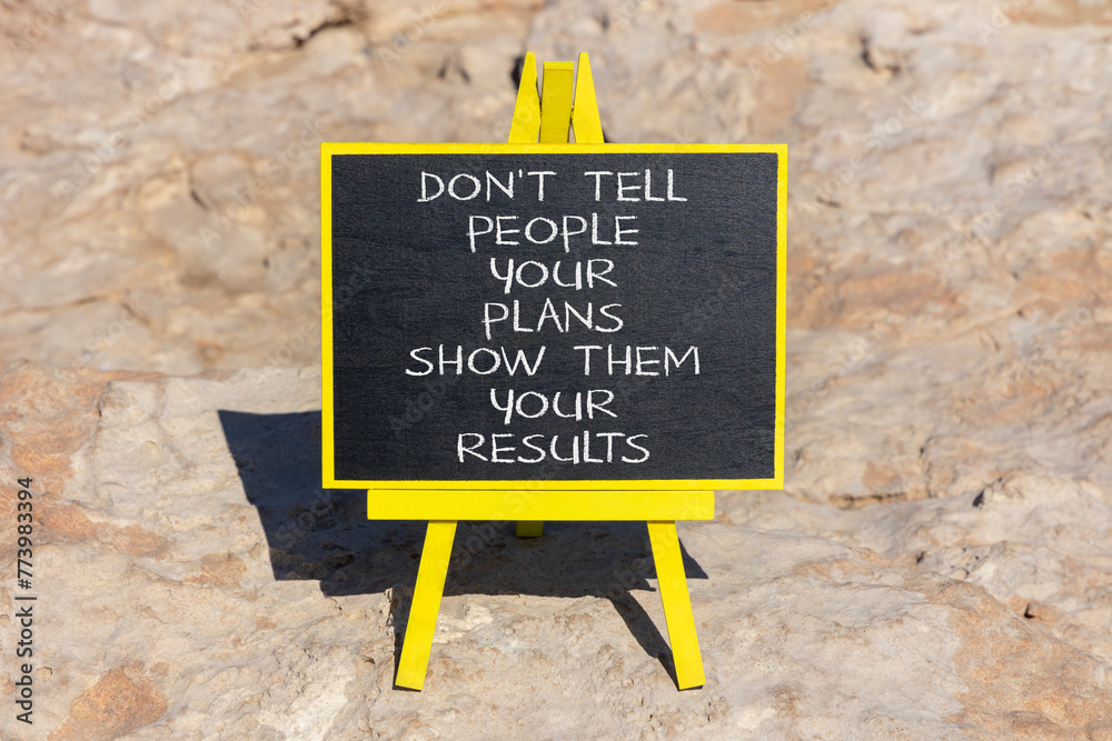 Fototapeta premium Plan or result symbol. Concept words Do not tell people your plans show them your results on beautiful black blackboard on a beautiful stone background. Business plan or result concept. Copy space.