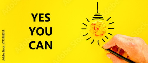 Motivational Yes you can symbol. Concept words Yes you can on beautiful yellow paper. Beautiful yellow background. Light bulb. Businessman hand. Business motivational Yes you can concept. Copy space