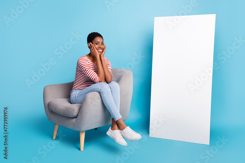 Full size photo of young cheerful man woman sit lounger promoter hands touch cheeks isolated over blue color background © deagreez