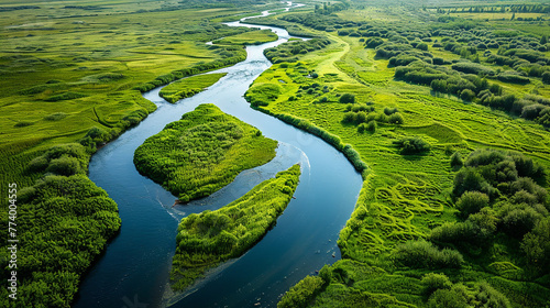 A tranquil river winding its way through lush green countryside, its glassy surface reflecting the vibrant colors of the surrounding landscape.