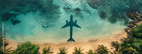 Aerial View of Airplane Shadow Over Tropical Beach Shoreline