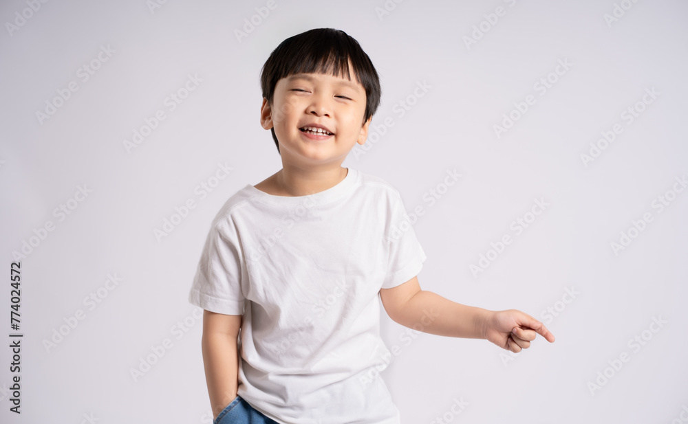 Portrait of an Asian boy posing on the white background Portrait of an Asian boy posing on the white background