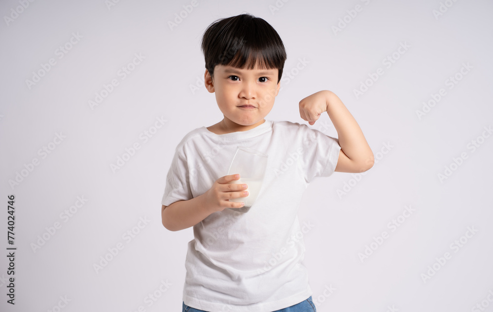 Portrait of asian boy drinking milk and posing on white background Portrait of asian boy drinking milk and posing on white background