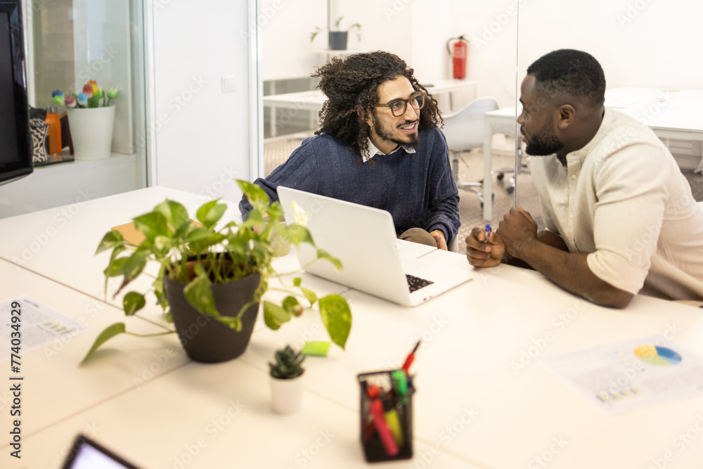 Middle Eastern and Black men in a work discussion at office Middle Eastern and Black men in a work discussion at office