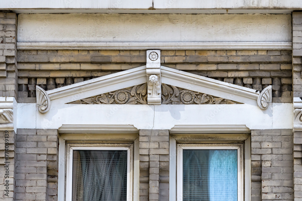 Fototapeta premium Ancient pediment over colonial building window, Toronto, Canada