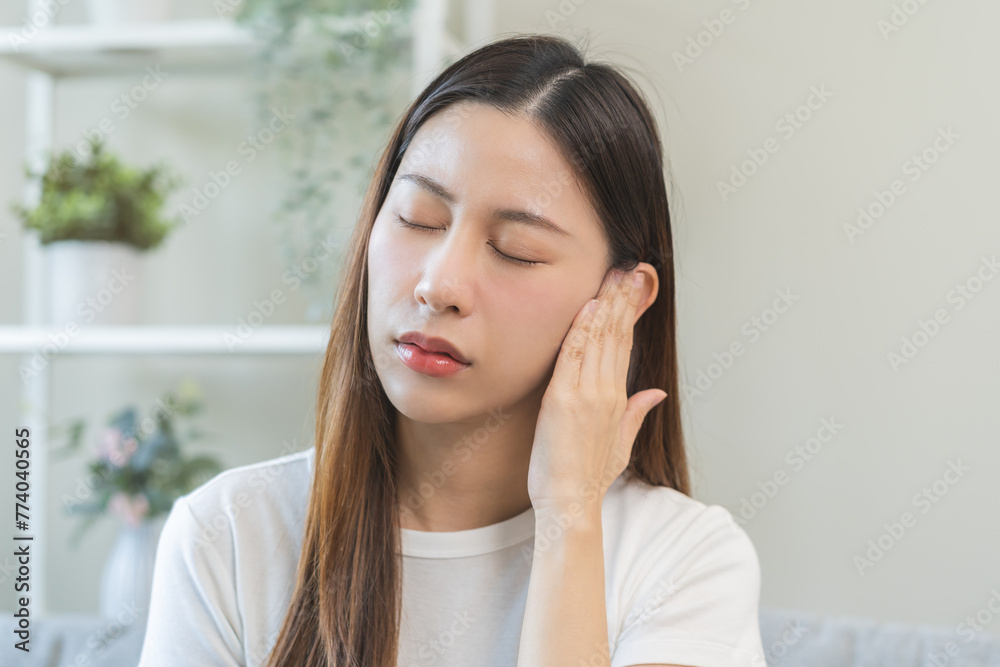 Tinnitus concept, sick asian young woman, girl have ear pain or earache, hand touch plug ear, suffering painful otitis from loud of noisy sound, inflammation. Health care nerve deaf eardrum disease. Tinnitus concept, sick asian young woman, girl have ear pain or earache, hand touch plug ear, suffering painful otitis from loud of noisy sound, inflammation. Health care nerve deaf eardrum disease.