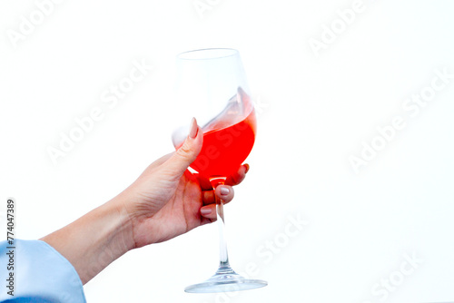 hand of a girl with wine in her hands on a white background
