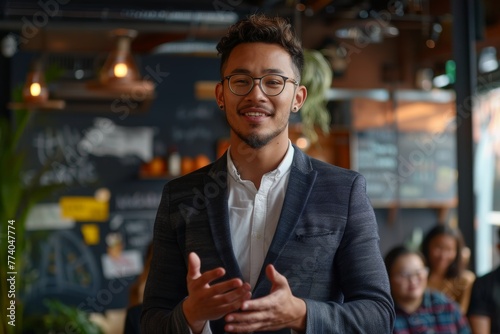 Confident Young Entrepreneur Speaking in a Modern Cafe
