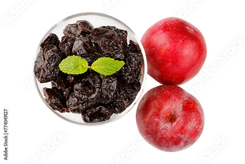 Dried plum in a glass bowl isolated on a white background top view