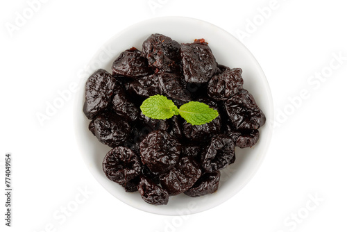 Dried plum in ceramic bowl isolated on a white background top view