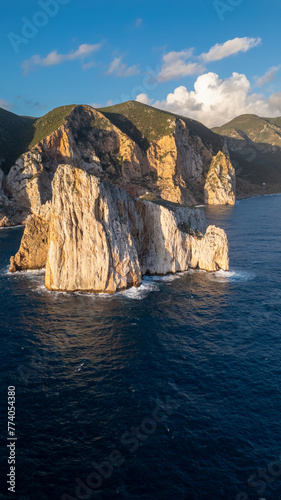 Rough sea in Sardinia near Porto Flavia. Aerial view of Pan di Zucchero and crystal clear sea