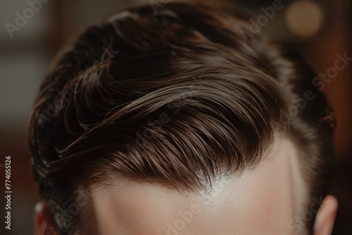Detailed photograph showcasing a modern side part hairstyle on a man with a clean and neat finish