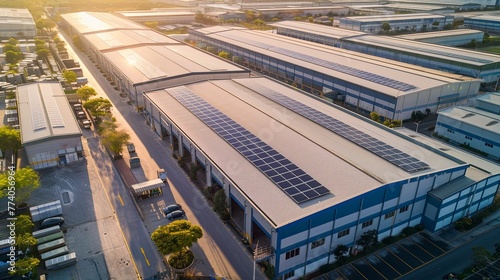 An industrial complex with a green twist, its buildings and parking canopies covered in solar panels, demonstrating the role of renewable energy in reducing the carbon footprint of manufacturing.