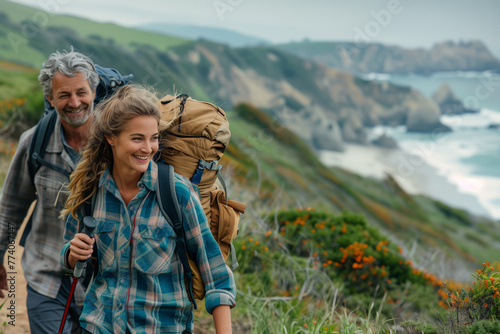 A cheerful middle-aged couple enjoys a scenic hike along a coastal trail, surrounded by lush greenery and the ocean backdrop, during a trip abroad.