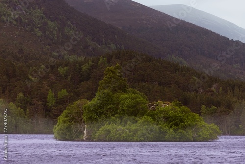 An island in the middle of a large body of water, Loch an Eilein, Cairngorms National park, Scotland photo