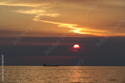 Fototapeta Naklejka Na Ścianę i Meble -  Ship in the open sea at scenic sunset in Trieste, Italy