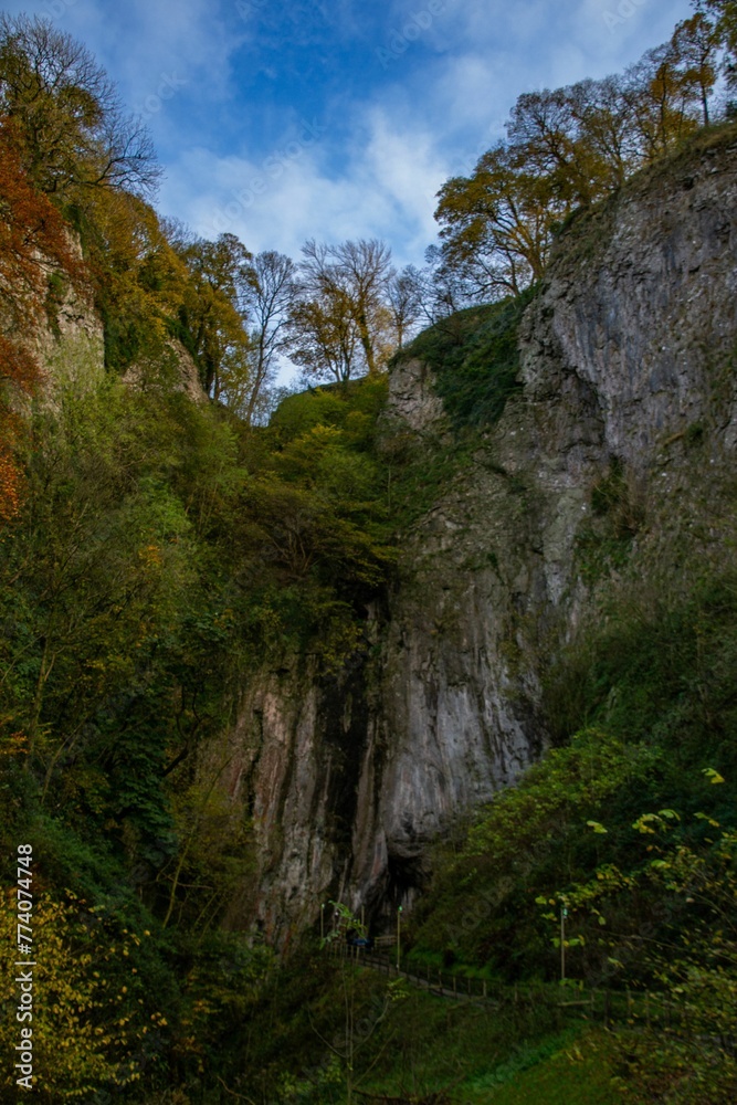 Vertical of the vast and rocky Peak Cavern cave in Castleton, United Kingdom Vertical of the vast and rocky Peak Cavern cave in Castleton, United Kingdom