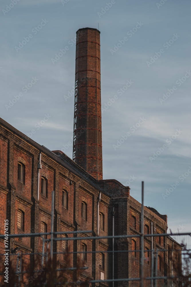 Vertical shot of an old malt factory building in Mistley, Essex, England
