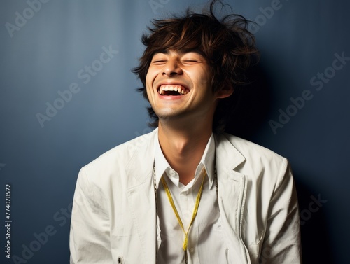 A man with a bright color shirt is smiling and laughing