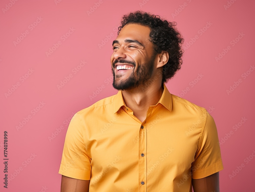 A man with a bright color shirt is smiling and laughing A man with a bright color shirt is smiling and laughing