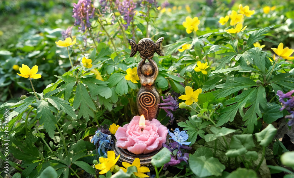 amulet of Triple Goddess Candlestick with flower candle on spring ...